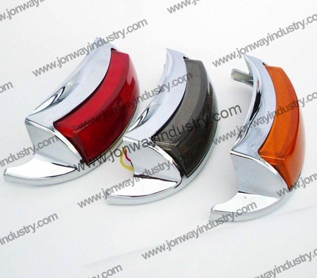 Chrome multifunctional LED tail light for Harley Davidson motorcycles with transparent, smoked, yellow, and red lens options.